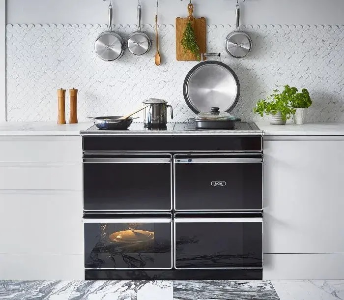 The black AGA ERA range cooker situated in a white kitchen.